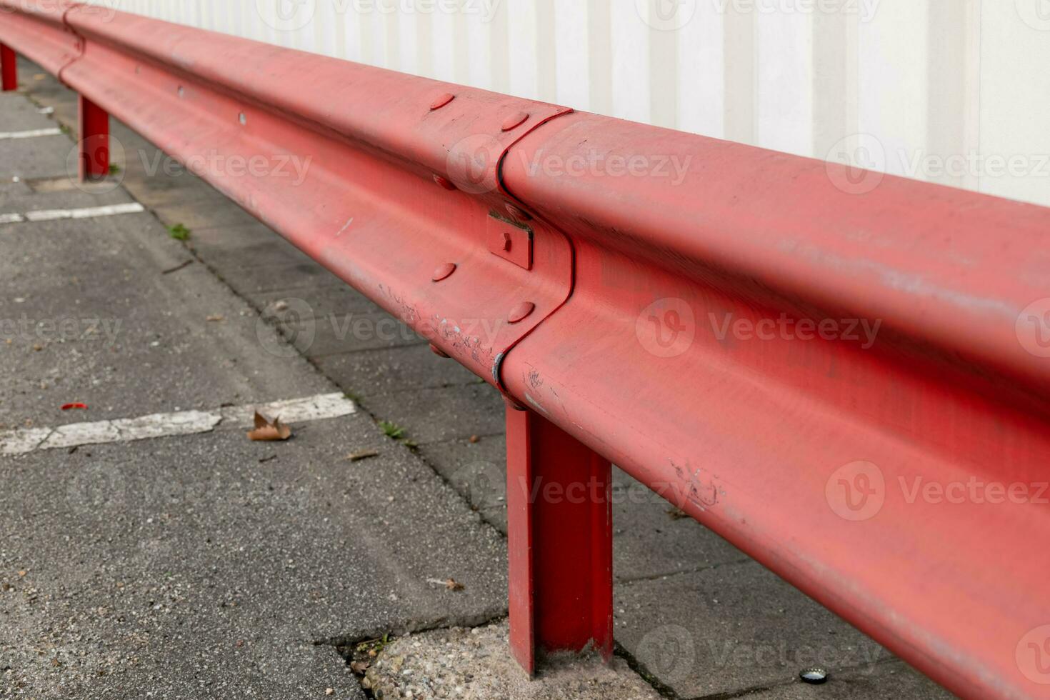 red guardrail in a parking lot photo