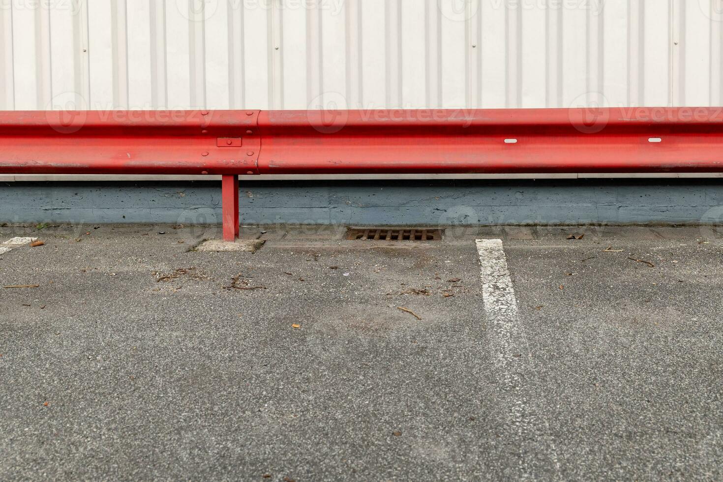 red guardrail in a parking lot photo