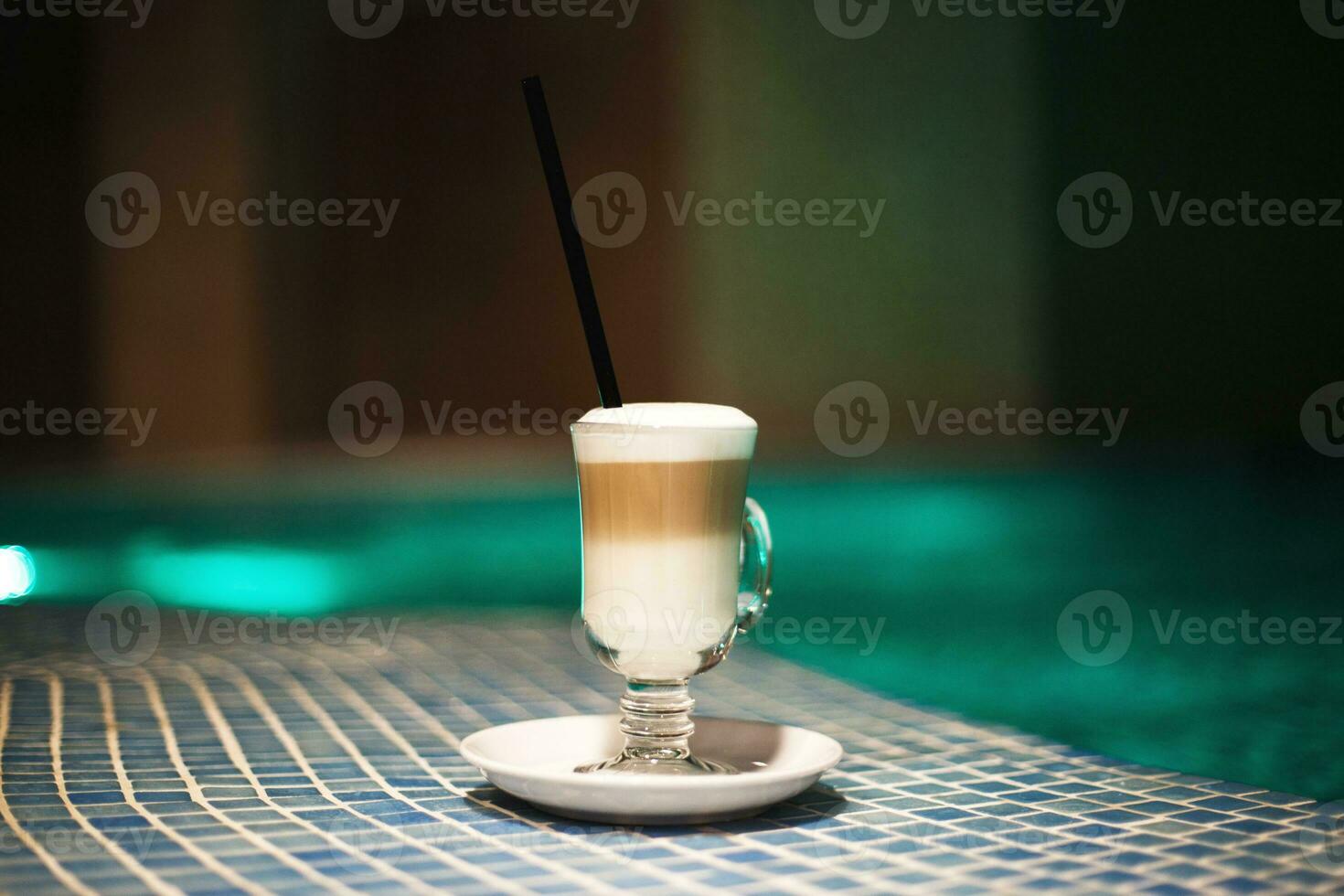 a cup of coffee on the side of the pool. rest in the spa center photo