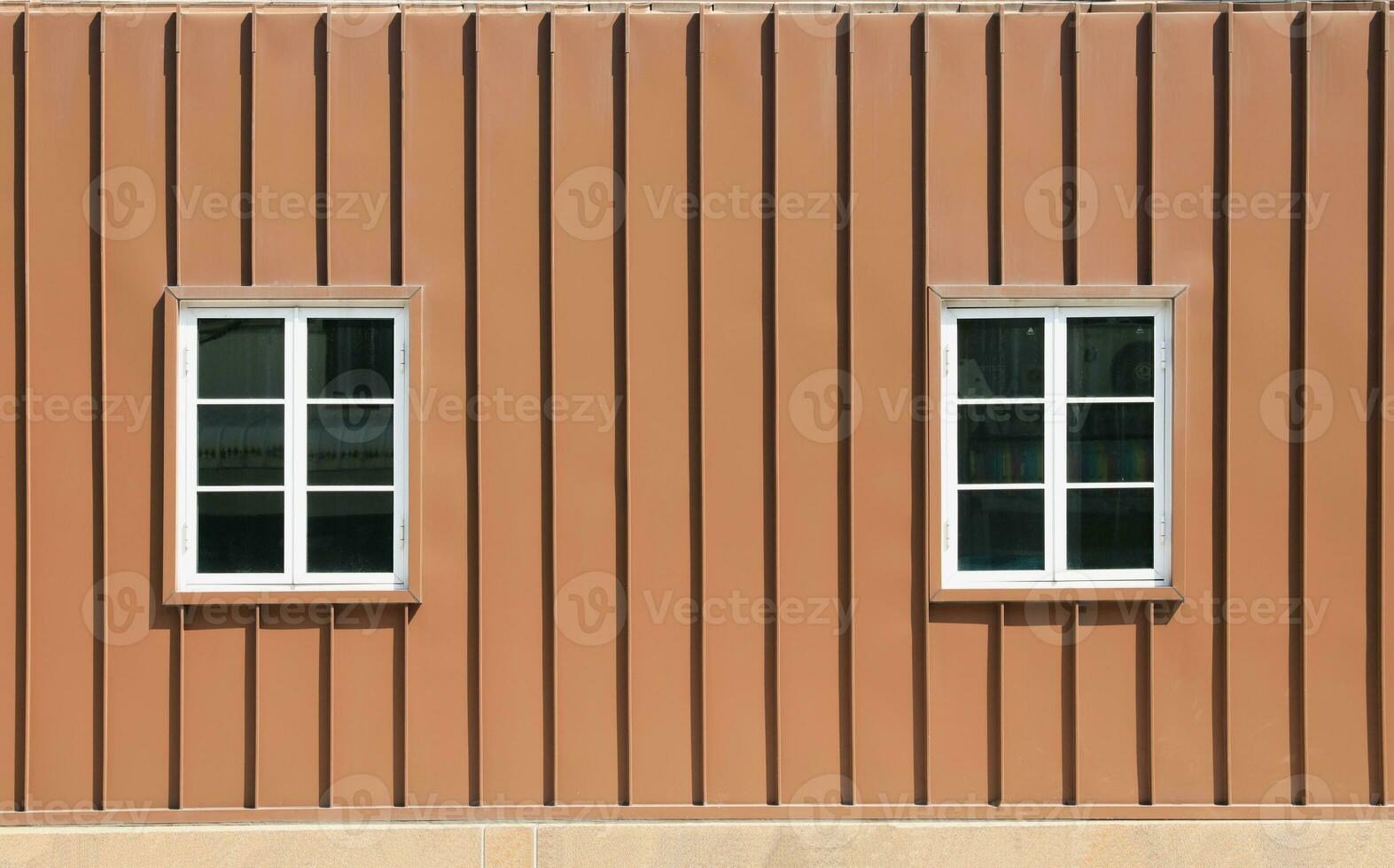 Facade of two windows on brown container wall photo