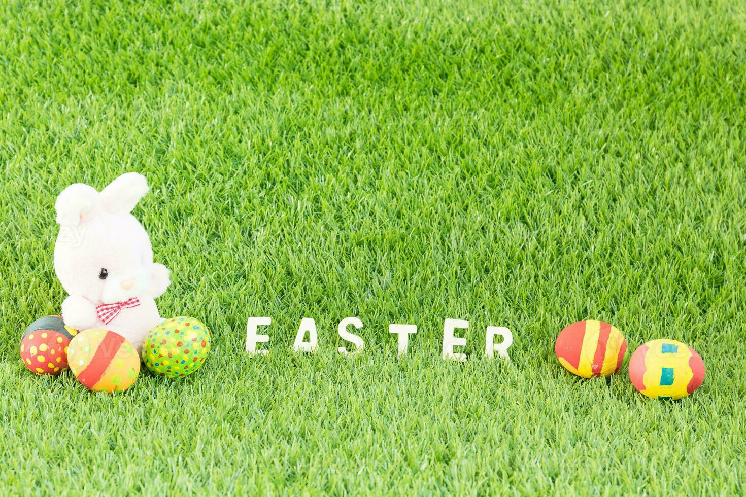 Bunny toy and Easter eggs with text photo