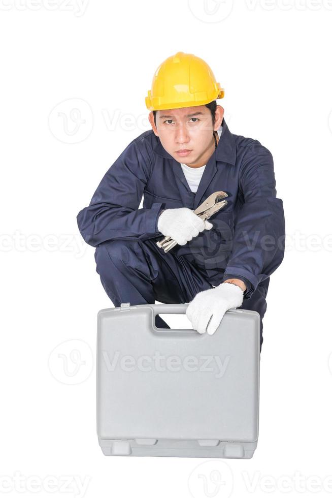 Young handyman sitting with his tool box photo