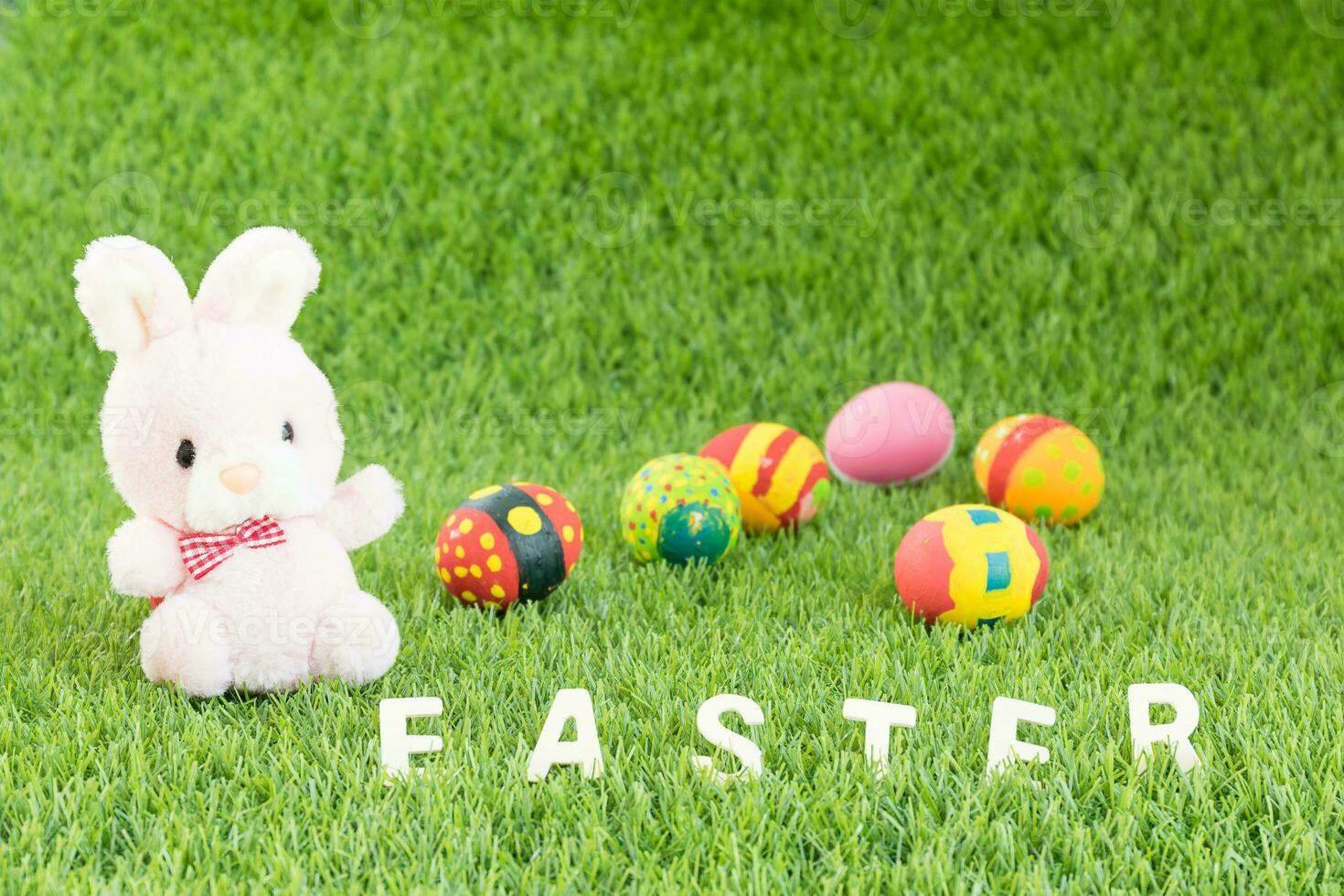 Bunny toy and Easter eggs with text photo