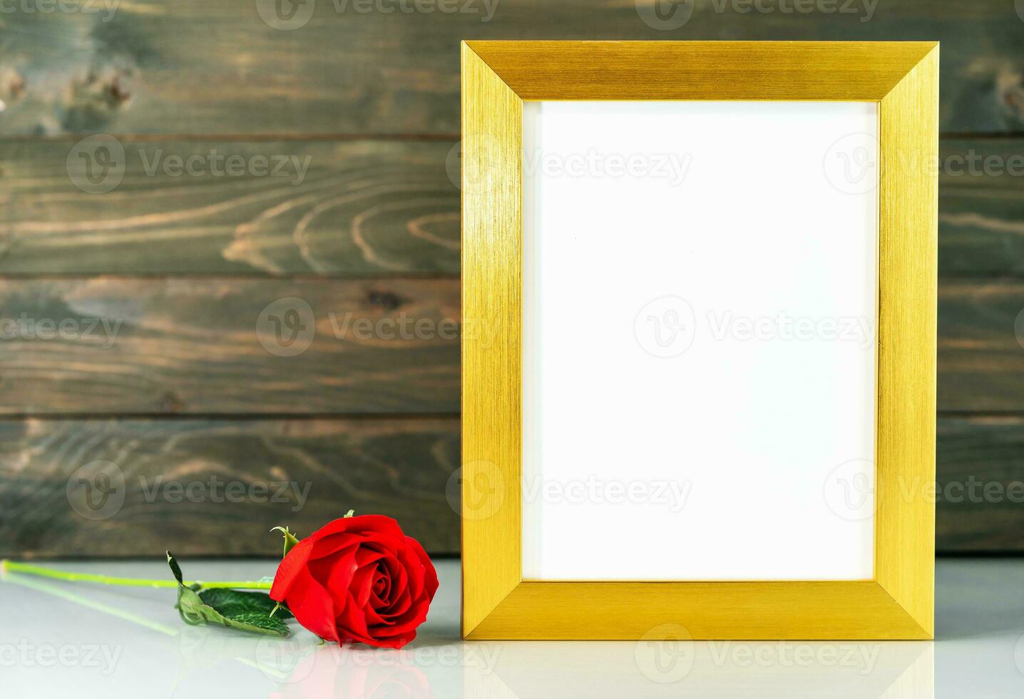 Picture mock up with golden frame on table with copy space photo