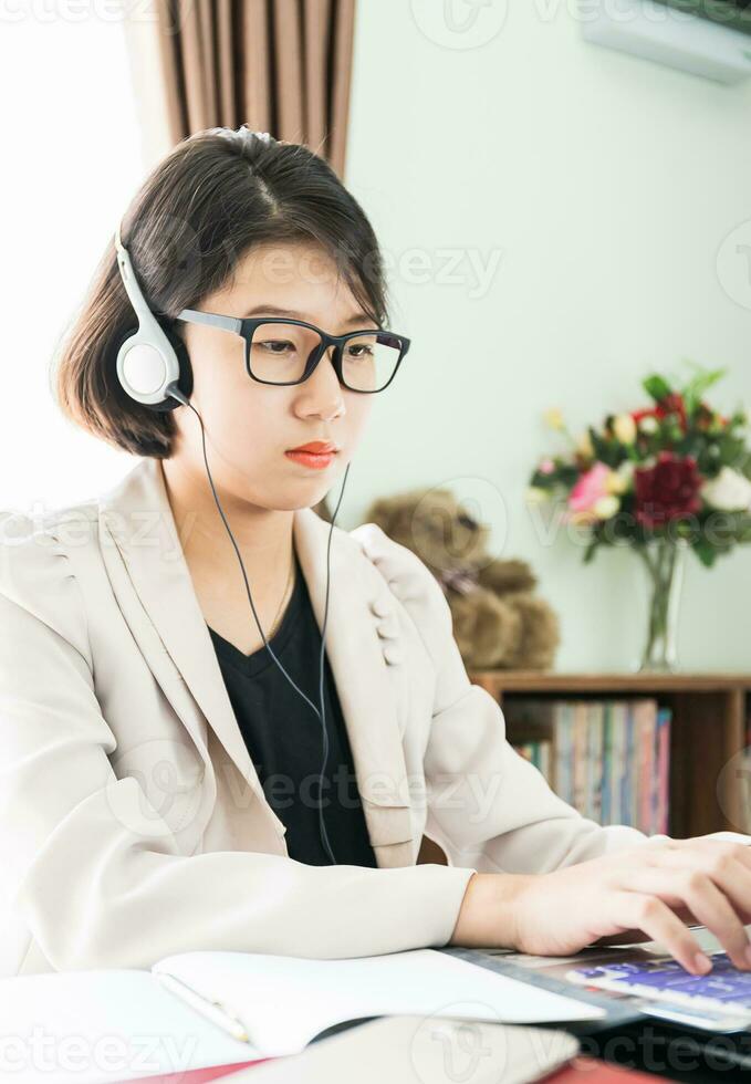 Teenage girl working on laptop in home office photo