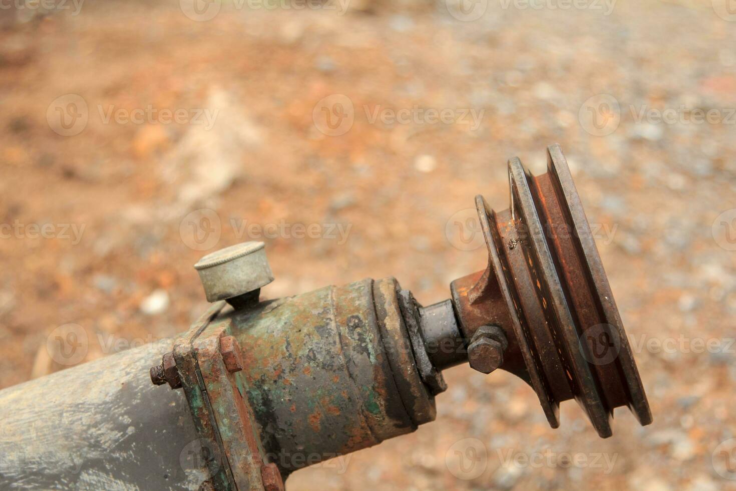 flywheel is a steel device to drive and connect the energy-saving water pumps that Thai farmers use to connect and irrigate the rice fields. photo