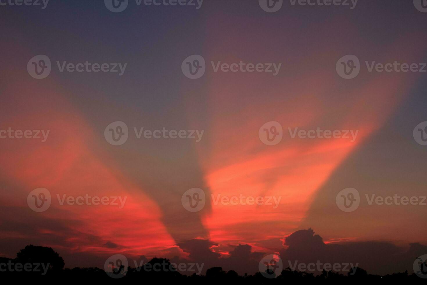 atmosphere in the evening sky as the sun sets - beams - of the sun and clouds create beautiful colors and many colors, creating a warm and romantic atmosphere on a summer evening. photo