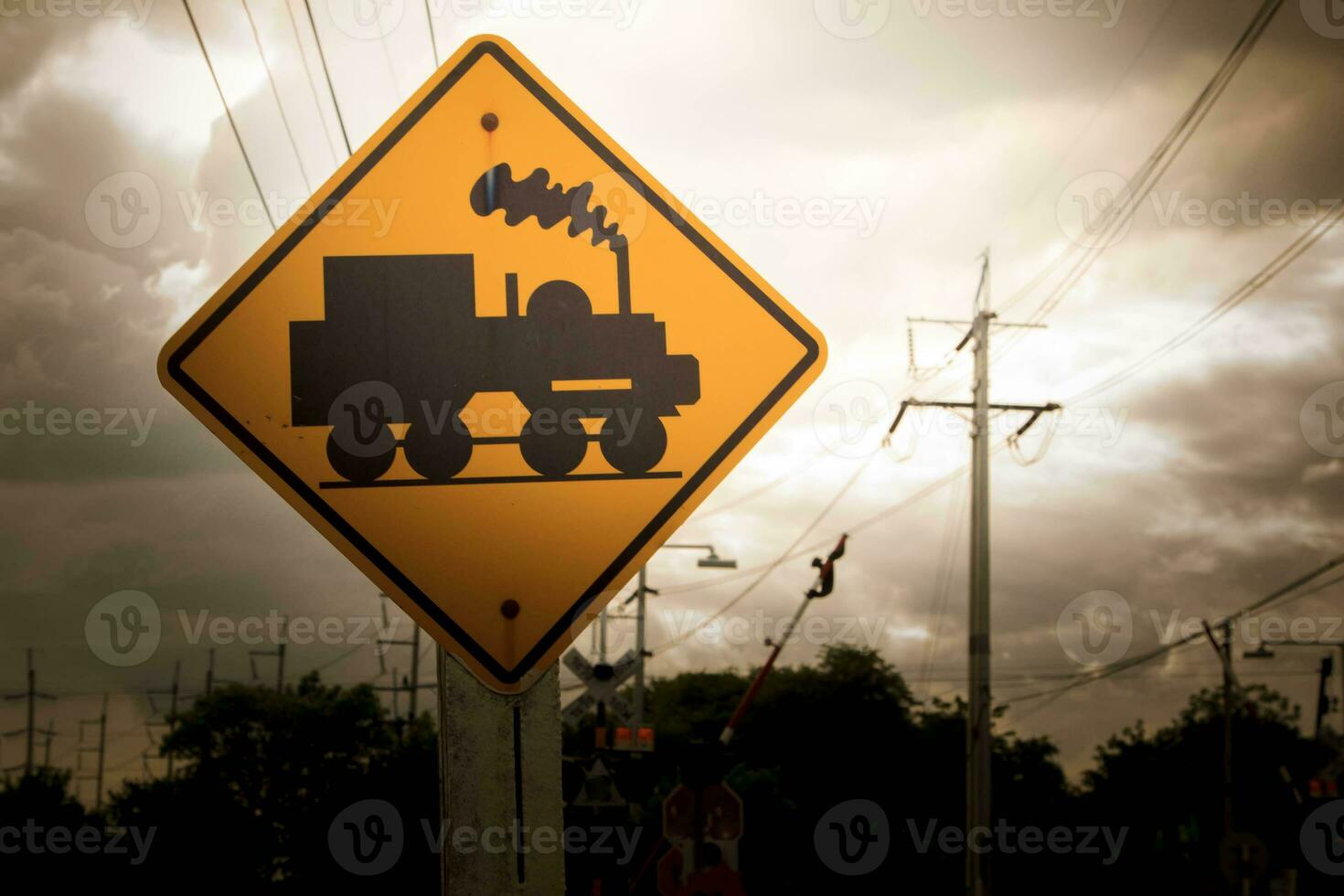 Traffic sign, watch out for the train. Drive slowly and watch out for the way ahead. There is a train passing by on rural roads of Thailand and the beautiful blue sky in the countryside. photo