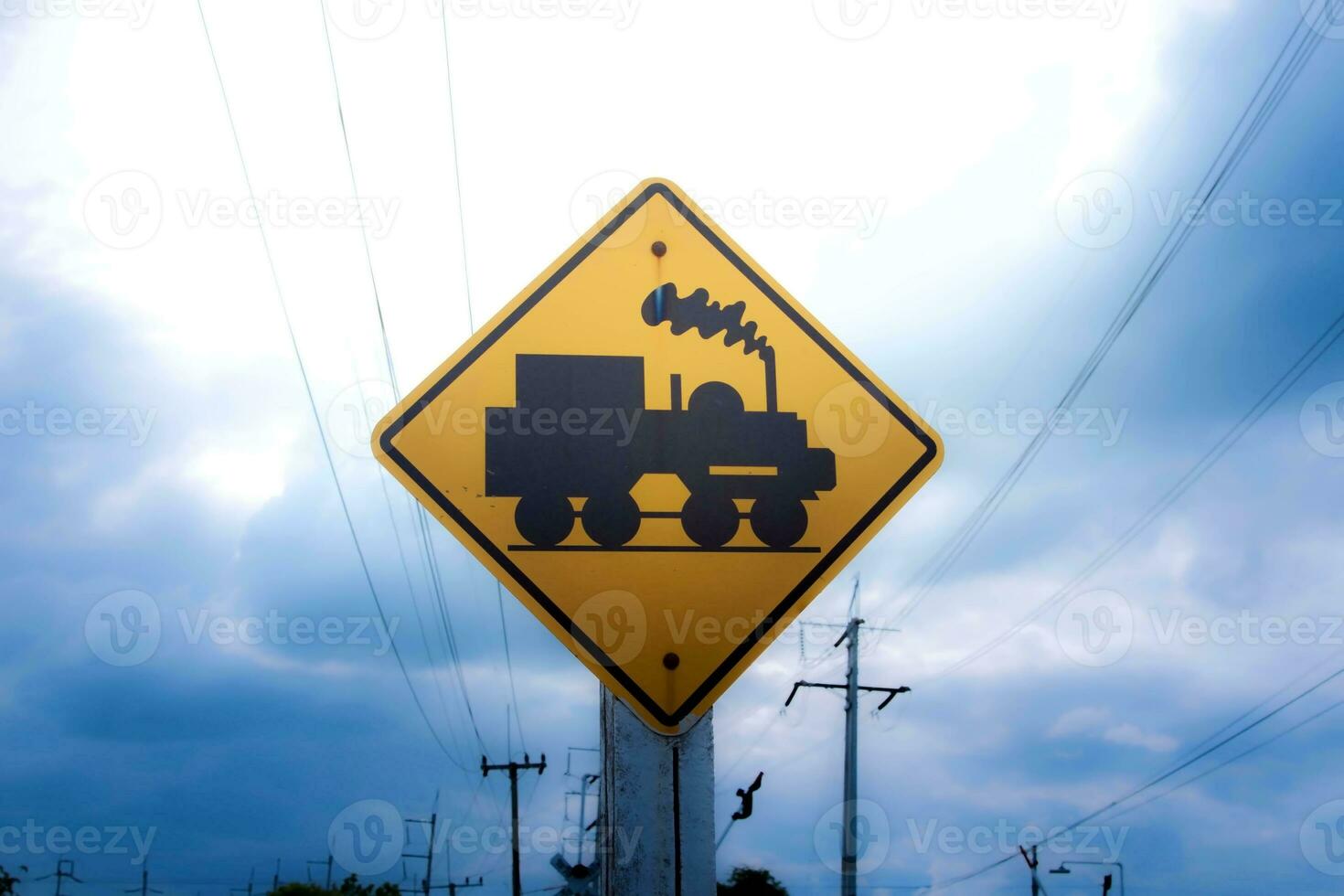 Traffic sign, watch out for the train. Drive slowly and watch out for the way ahead. There is a train passing by on rural roads of Thailand and the beautiful blue sky in the countryside. photo