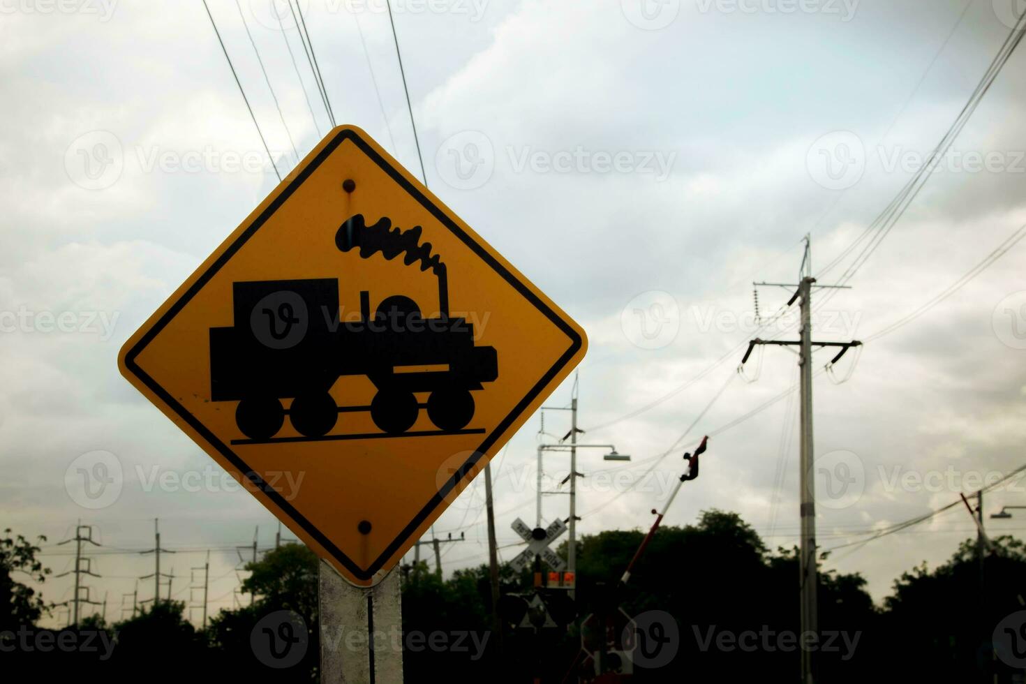 Traffic sign, watch out for the train. Drive slowly and watch out for the way ahead. There is a train passing by on rural roads of Thailand and the beautiful blue sky in the countryside. photo