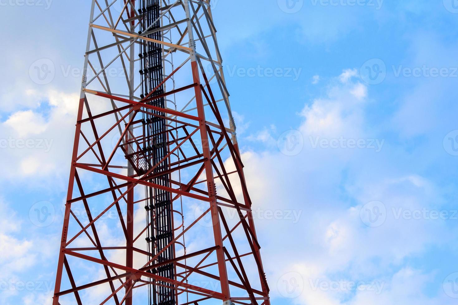 Steel and cable structure of tall telephone poles against beautiful evening blue sky background. photo