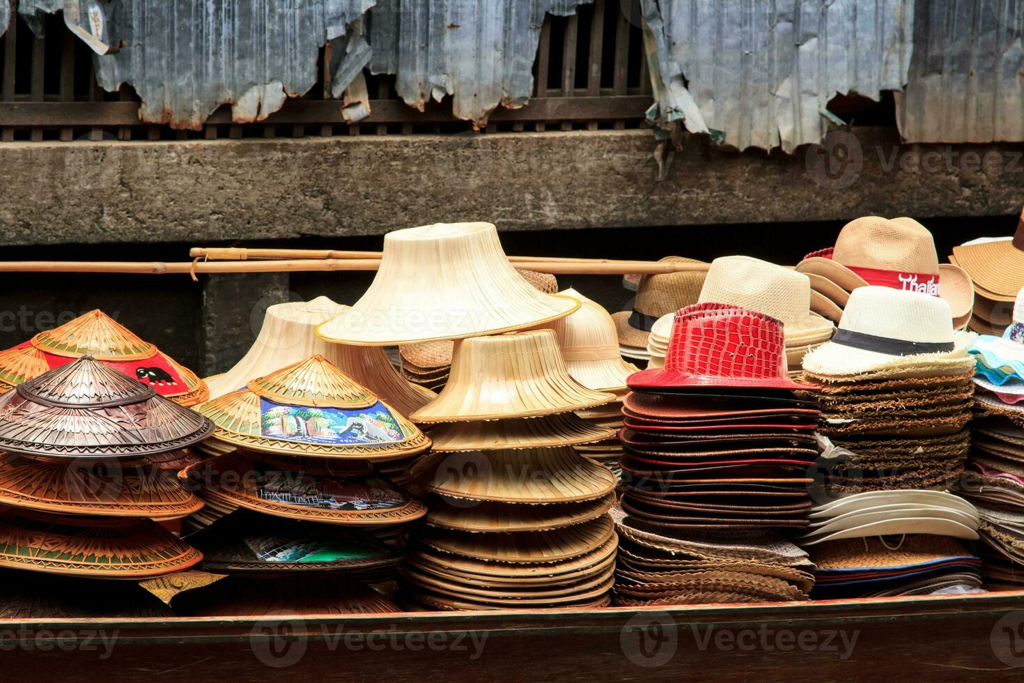Boats selling hats - Handmade weaving - Damnoen Saduak Floating Market is a popular tourist destination that Europeans and Chinese like to travel with the traditional way of life of the villagers. photo