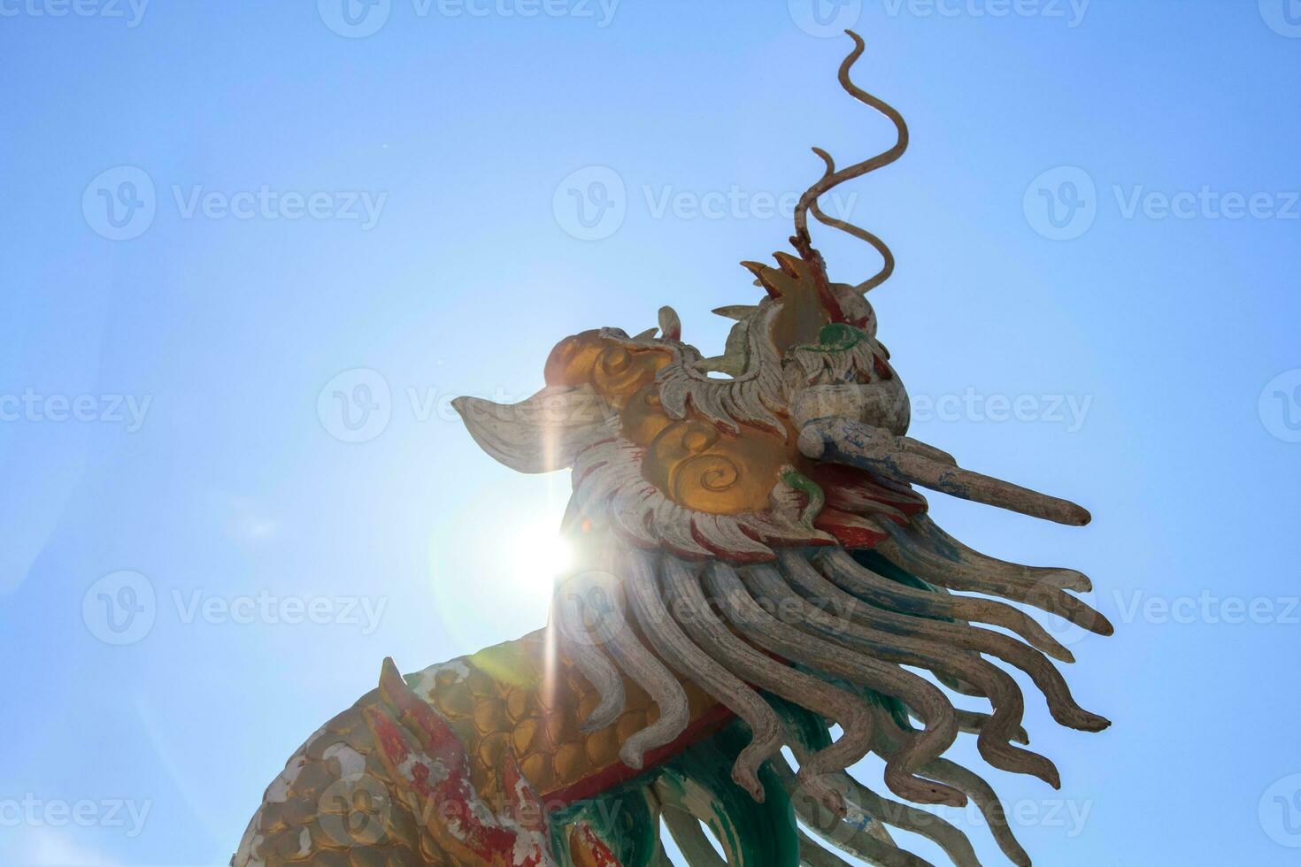 Stucco dragon is a Chinese sculpture and is a mythical creature that is popularly built in Chinese temples and shrines. It is a delicate art created by skilled craftsmen. photo