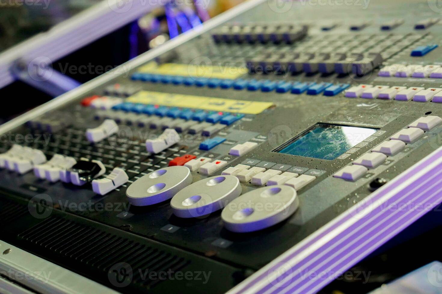 Closeup and crop of knobs with button of sound music mixer control panel in party lights refection and blurry background. photo