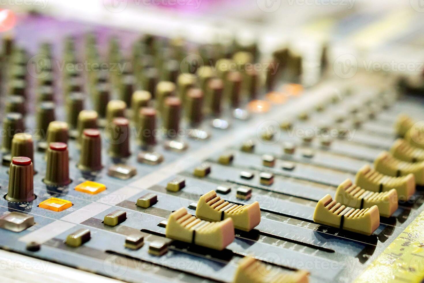 Closeup and crop of knobs with button of sound music mixer control panel on blurry background. photo