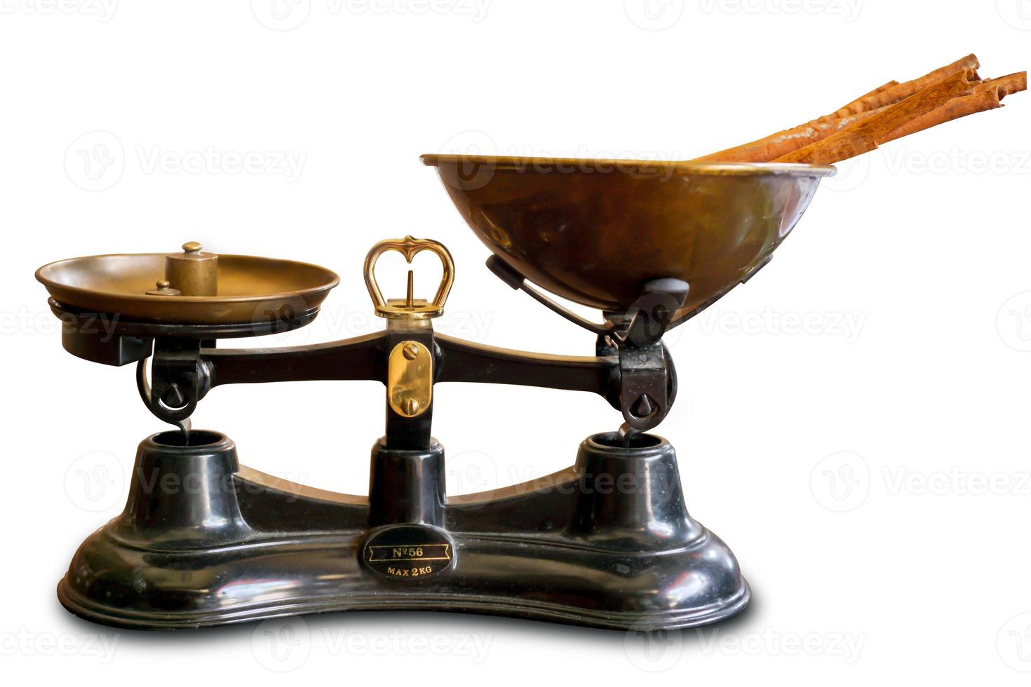 Ancient scales with brass weight pendulum and Thai herbs weight balance on brass tray isolate on white background and make with path. photo