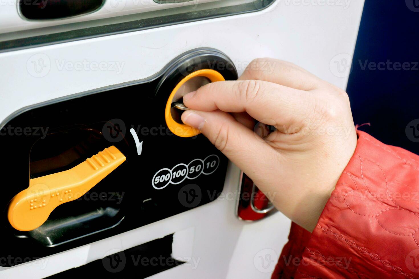 Hand of one people holding currency coin purchasing a soft drink form drink vending machine. photo