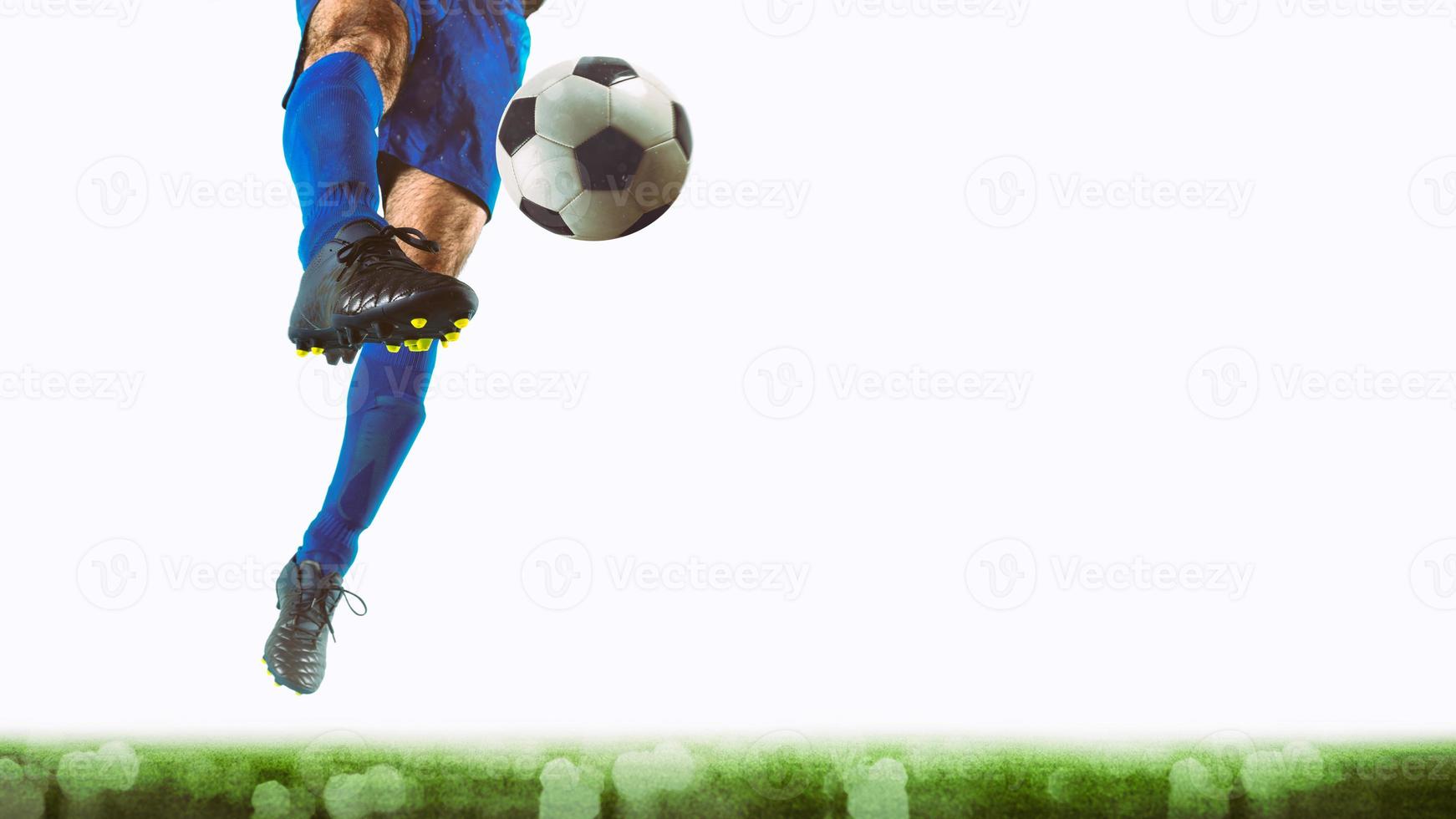 Close up of a striker who kicks the ball to make goals on a white background photo