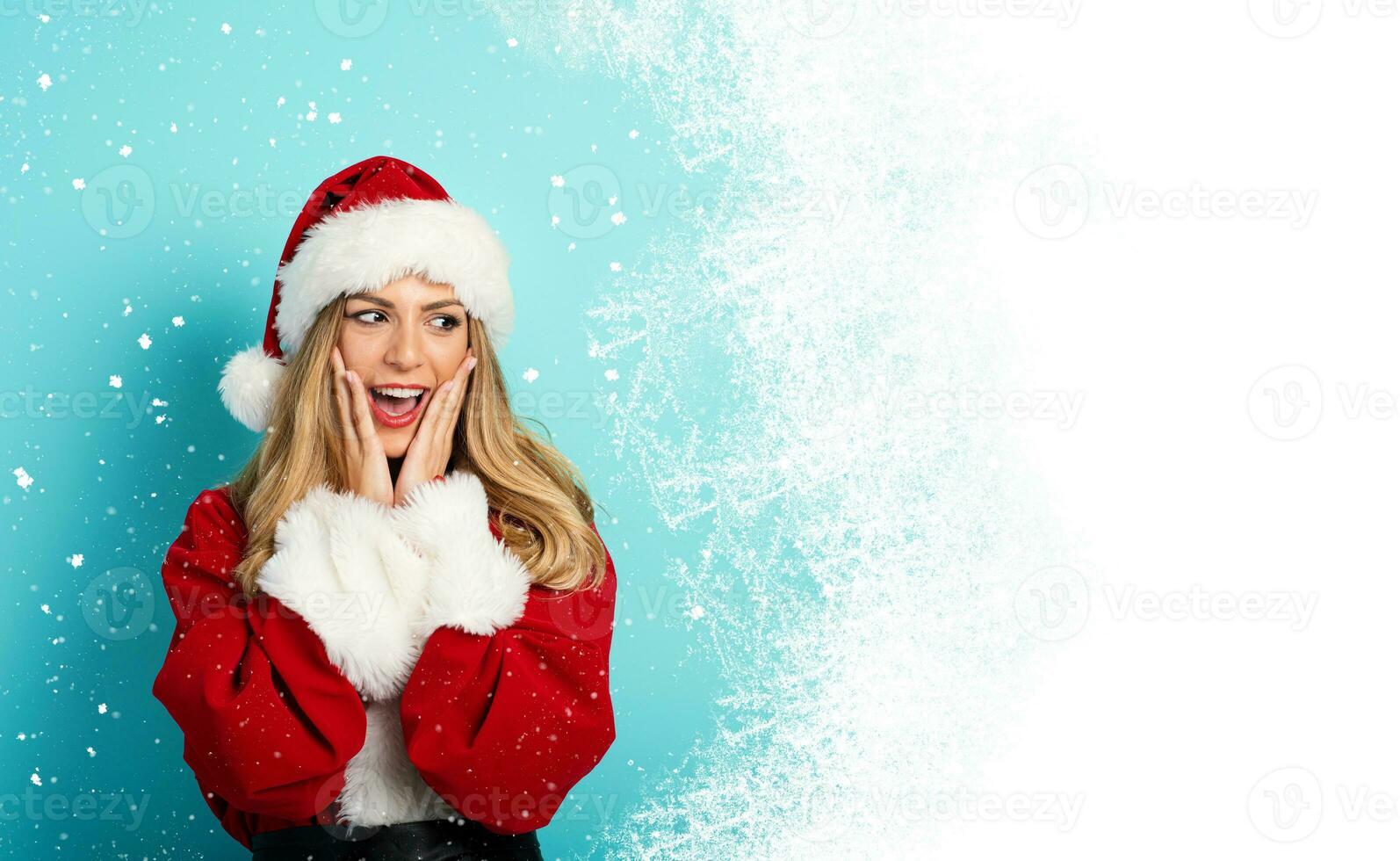 Woman with santa claus costume and surprised expression. White space for your text photo