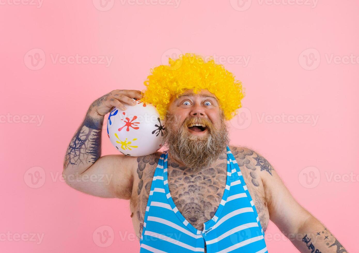 Fat amazed man with beard and wig play with the ball photo