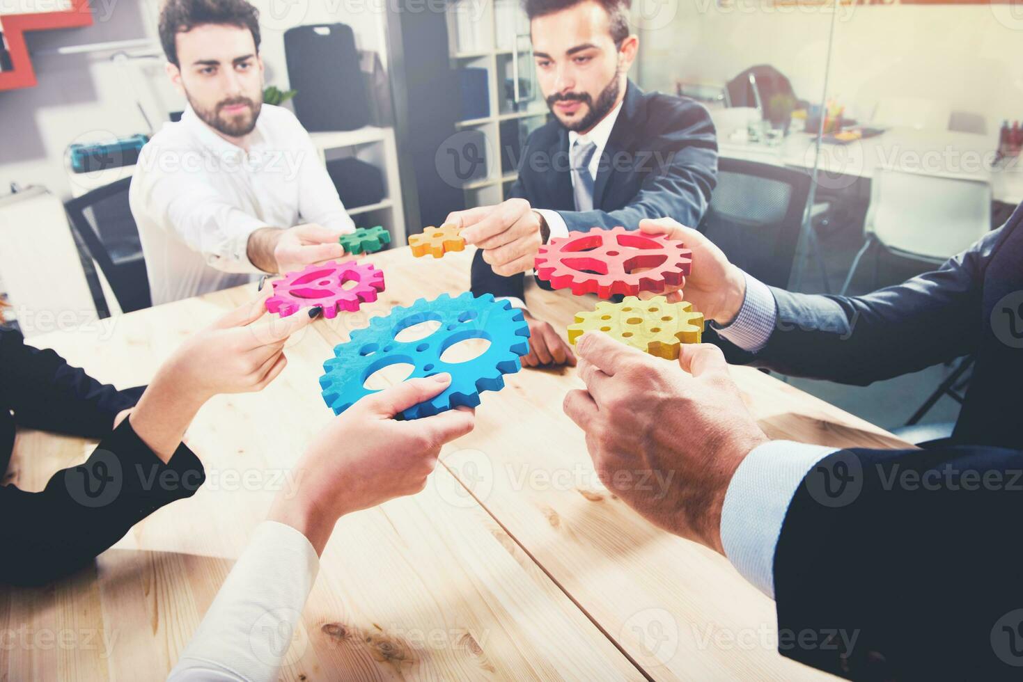 Business team connect pieces of gears. Teamwork, partnership and integration concept photo