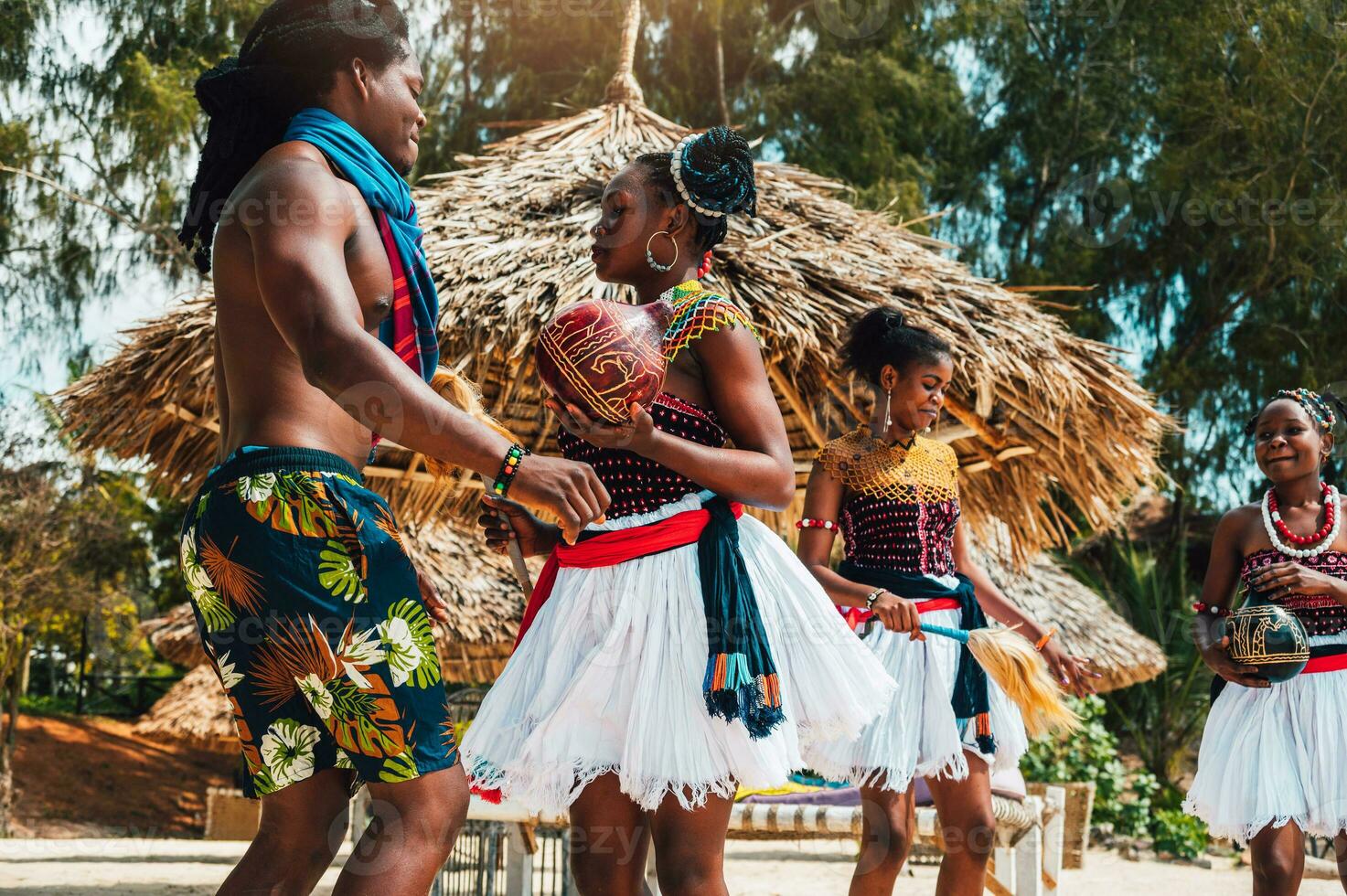 Kenyan people dance on the beach with typical local clothes photo