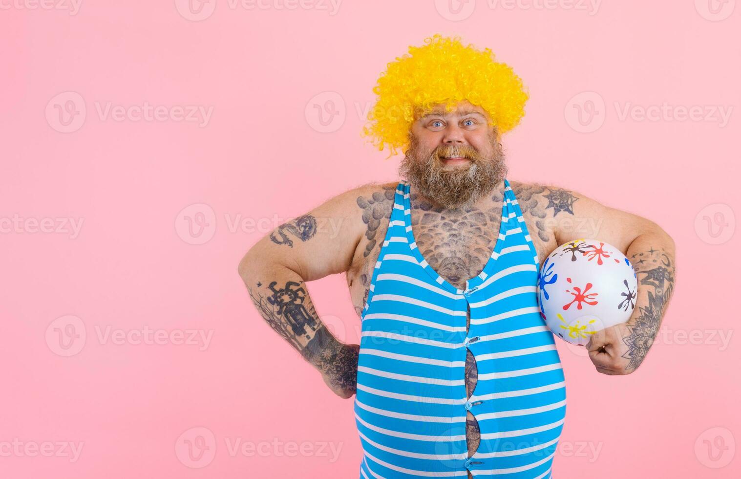 Fat happy man with beard and wig play with the ball photo