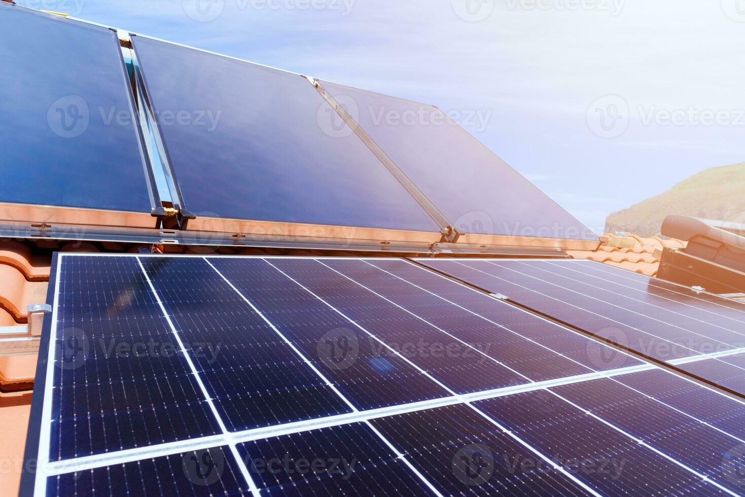 Renewable energy system with solar panel for electricity and hot water photo