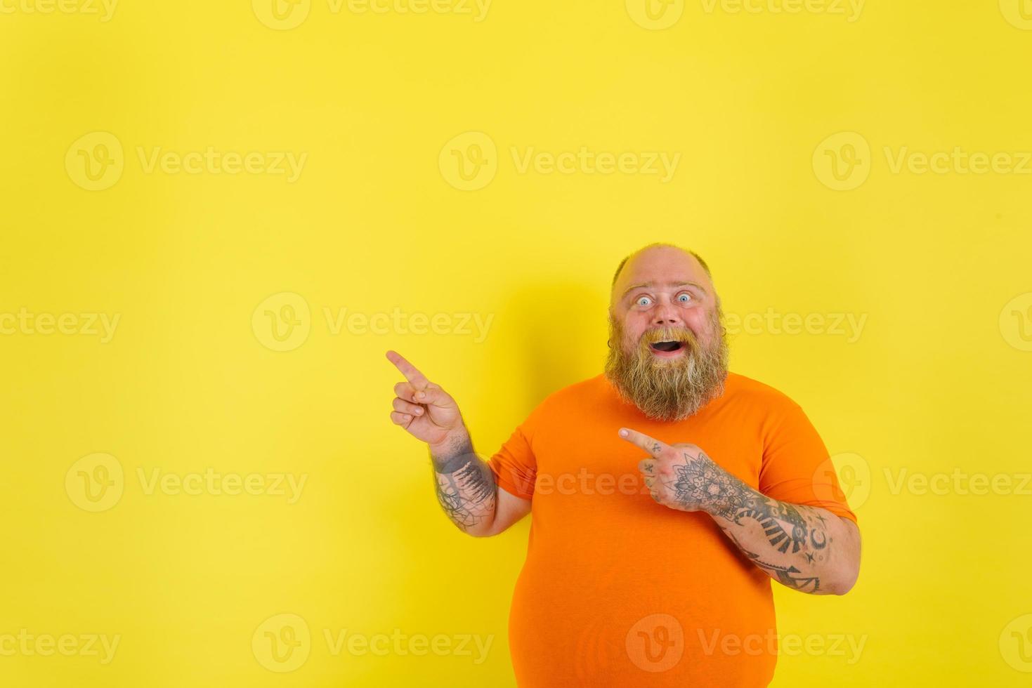 Amazed man with beard and tattoos is amazed about something photo