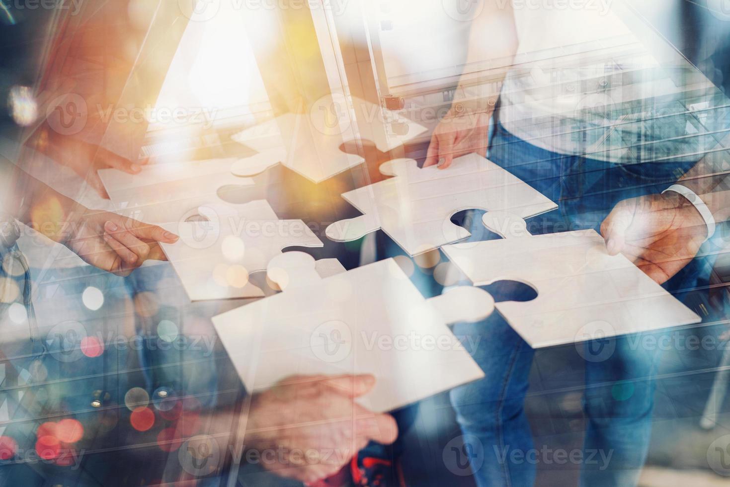 Teamwork of partners connect puzzle pieces as integration and startup photo