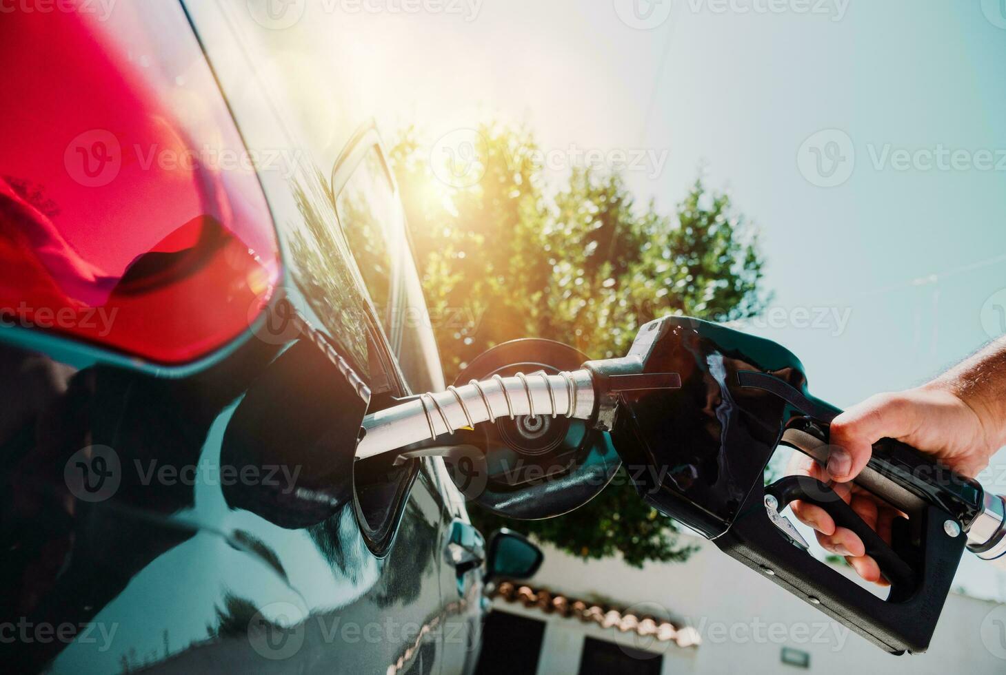 Fuel pump fill a tank of a car in a station photo