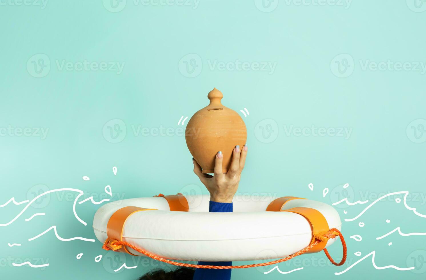 Person is drowning and wants to save her moneybox. concept of bankruptcy and crisis. Cyan background photo