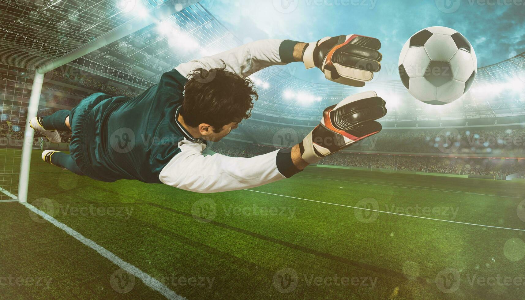 Goalkeeper catches the ball in the stadium during a football game photo