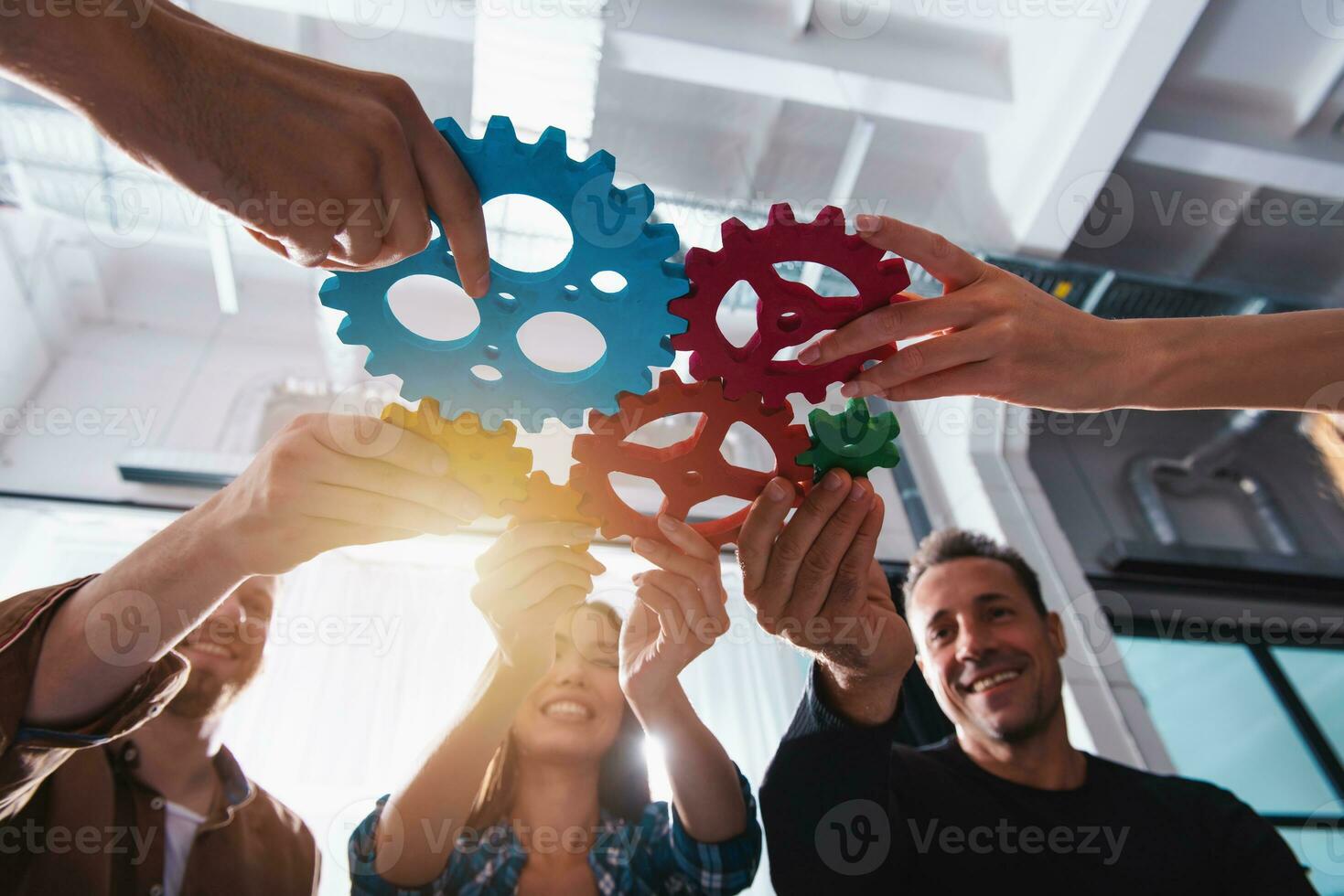 Business team connect pieces of gears. Teamwork, partnership and integration concept photo