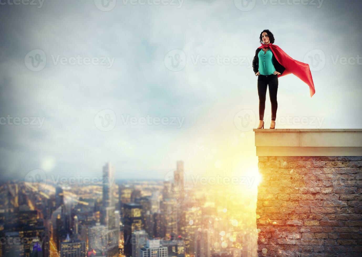 Successful businesswoman acts like a super hero above the roof of a building. Concept of determination and success photo