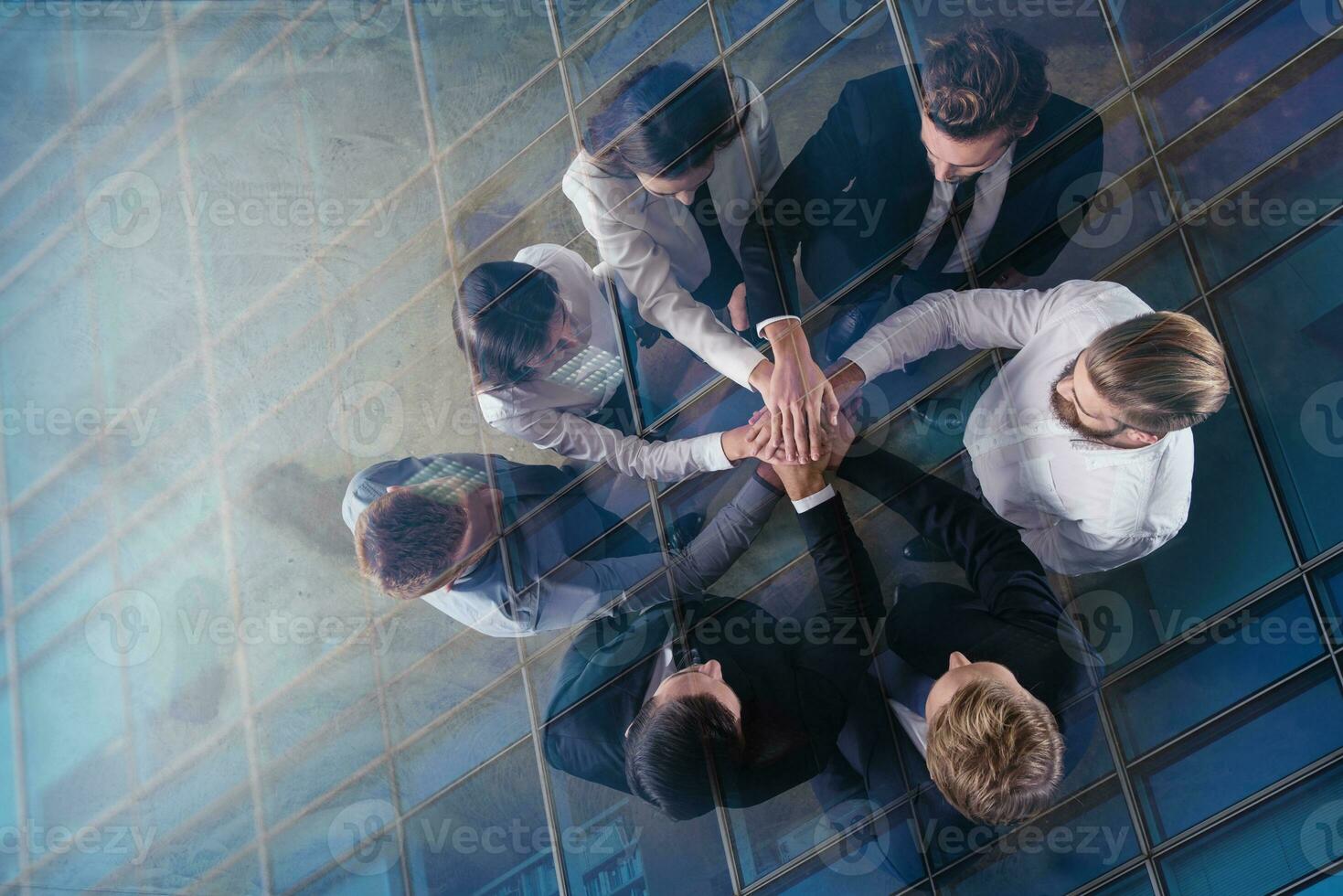 Business people putting their hands together. Concept of integration, teamwork and partnership. double exposure photo
