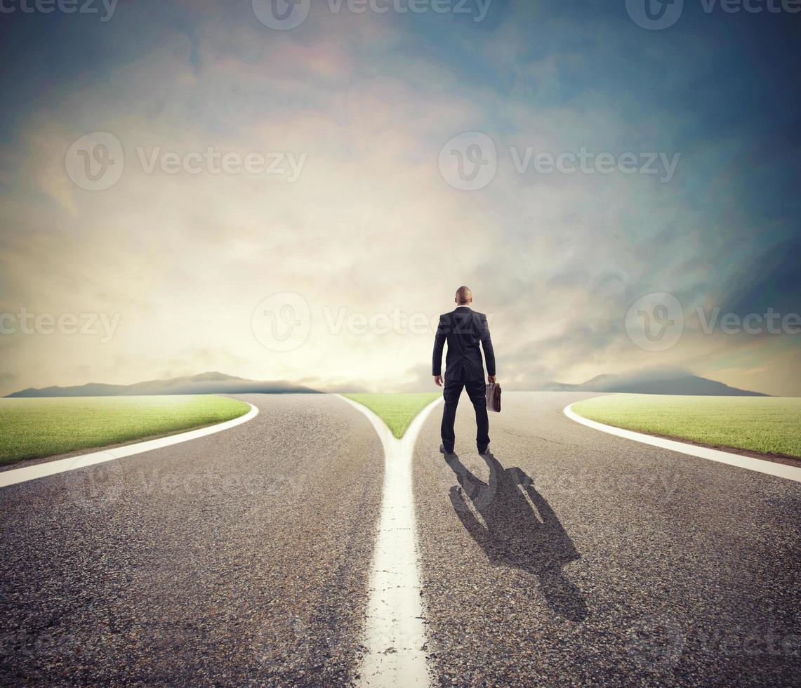 Businessman in front of a crossway must select the right way photo