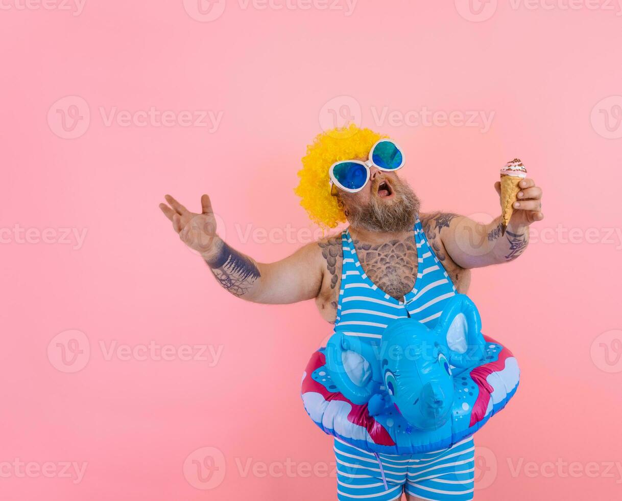 Fat man with beard and wig eats an icecream photo