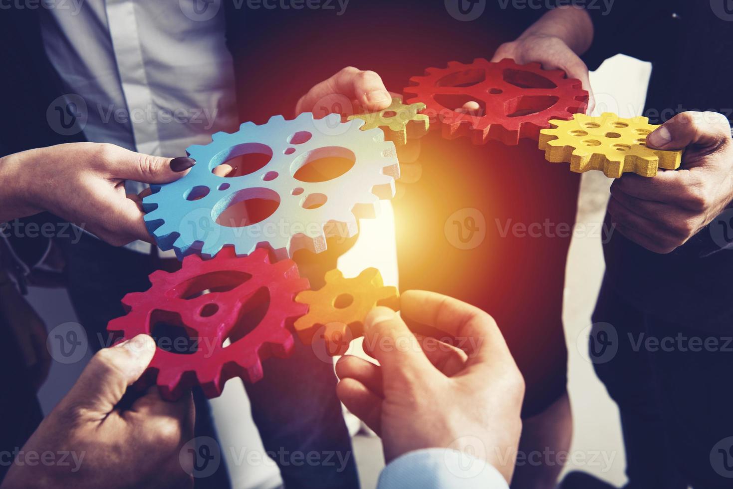 Business team connect pieces of gears. Teamwork, partnership and integration concept photo
