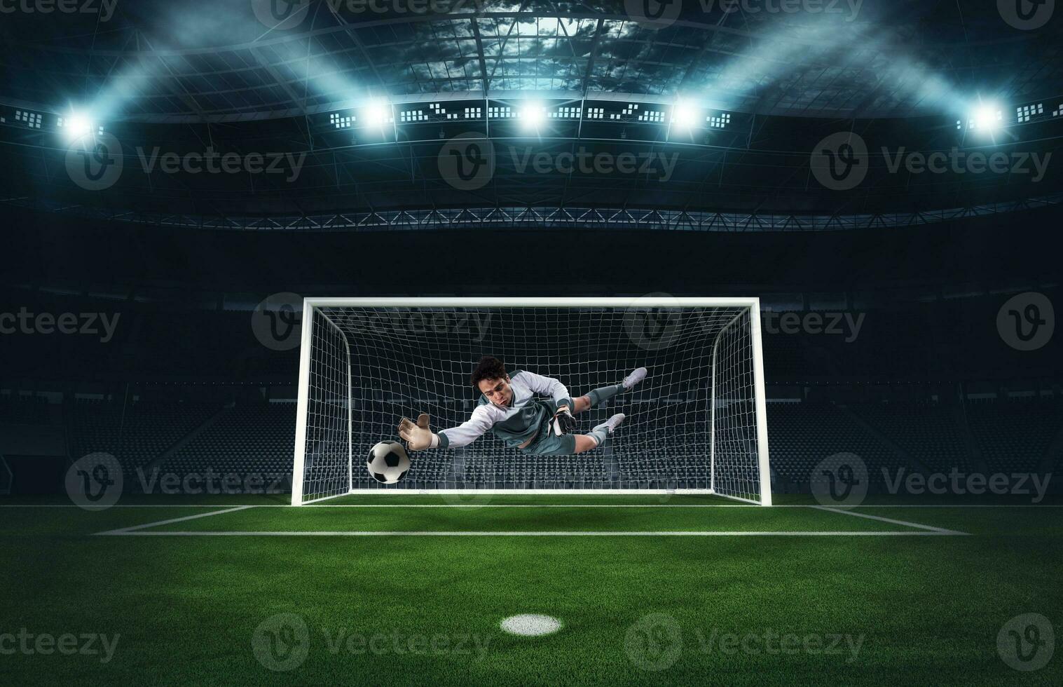 Soccer goalkeeper that makes a great save and avoids a goal during a match at the stadium photo