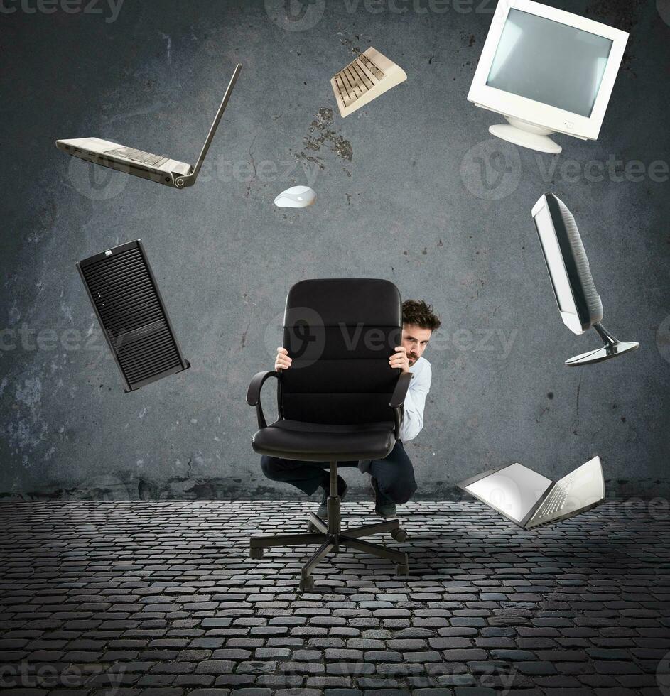 Businessman has fear of computers and technology photo