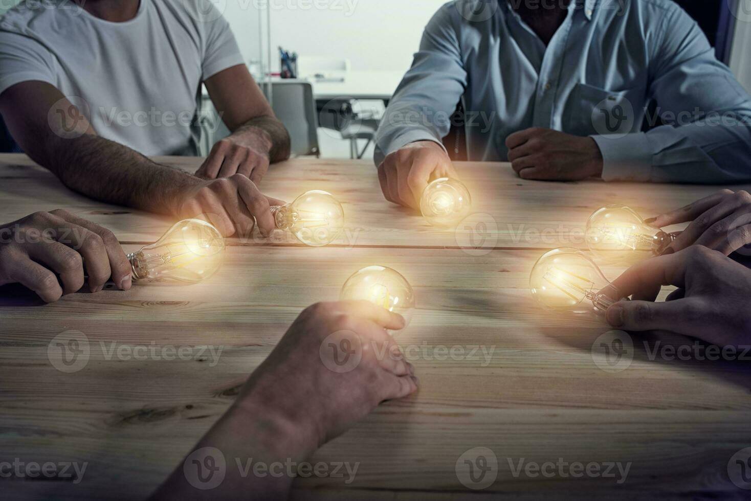 Teamwork and brainstorming concept with businessmen that share an idea with a lamp. Concept of startup photo