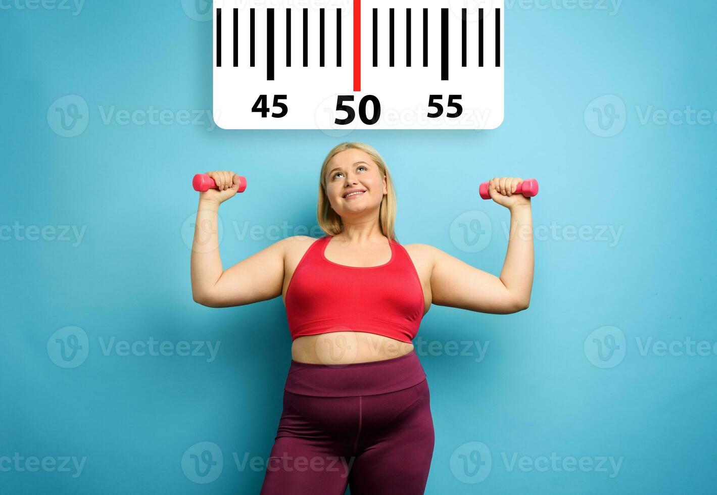 Fat girl does gym at home with satisfied expression because she decrease her weight. Cyan background photo