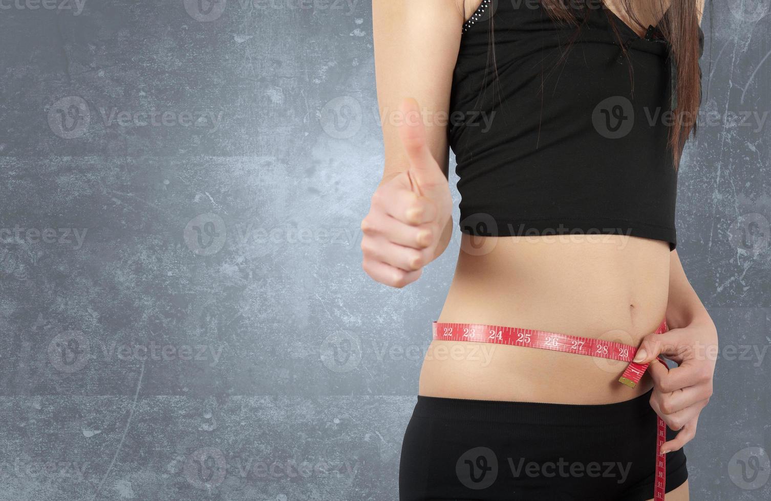 Woman Holds A Measuring Tape Around Her Waist Stock Photo, Picture