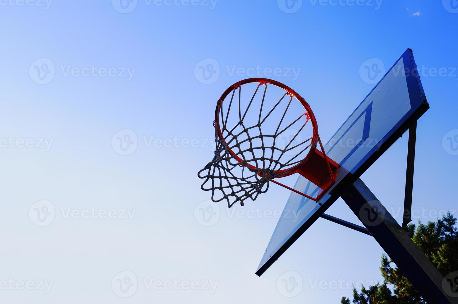 Basket in an outdoor playing field with clear sky photo
