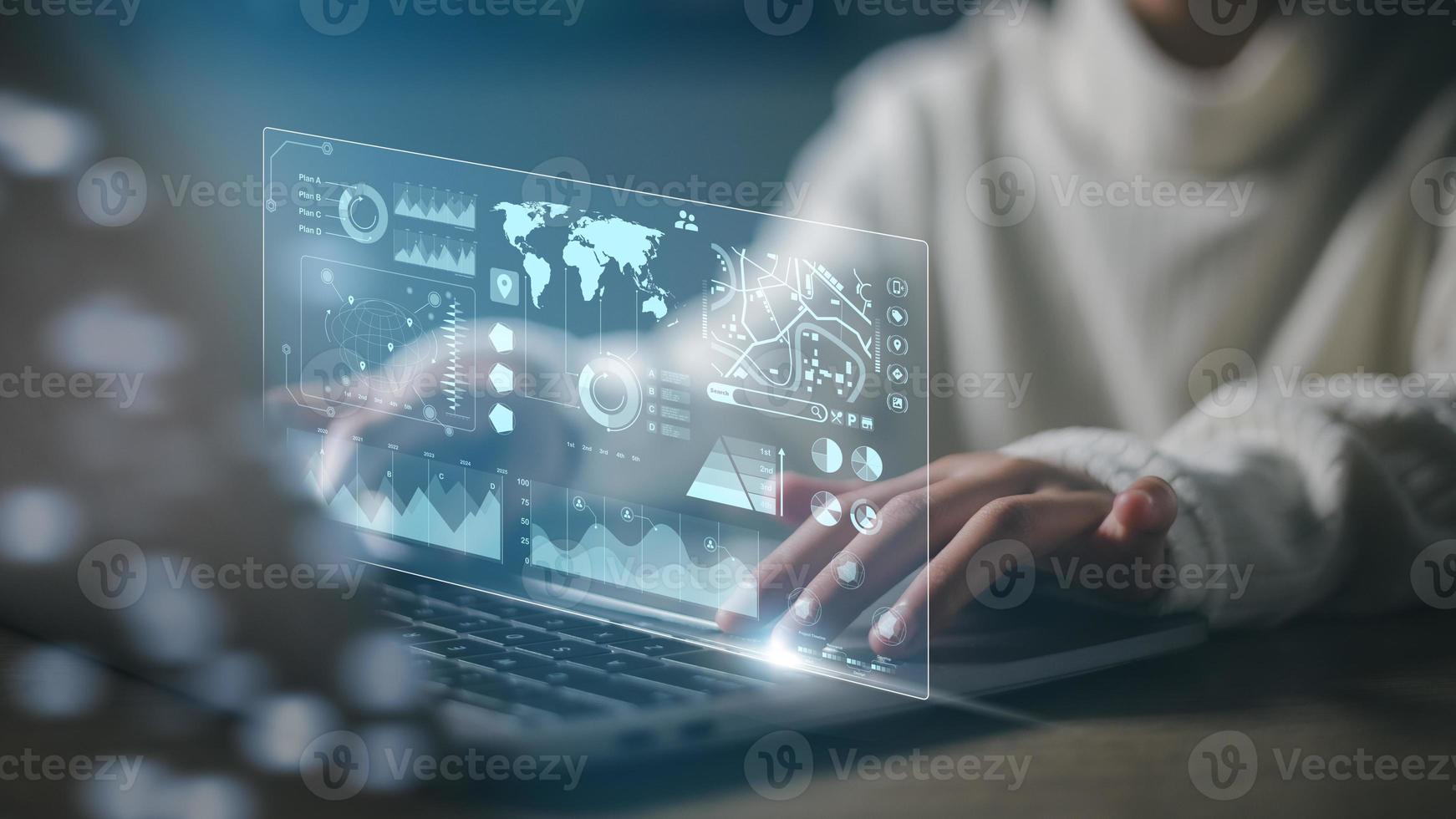 The programmer uses a laptop to analyze and developing at various information on a futuristic virtual interface screen. Algorithm. marketing and deep learning of artificial intelligence photo