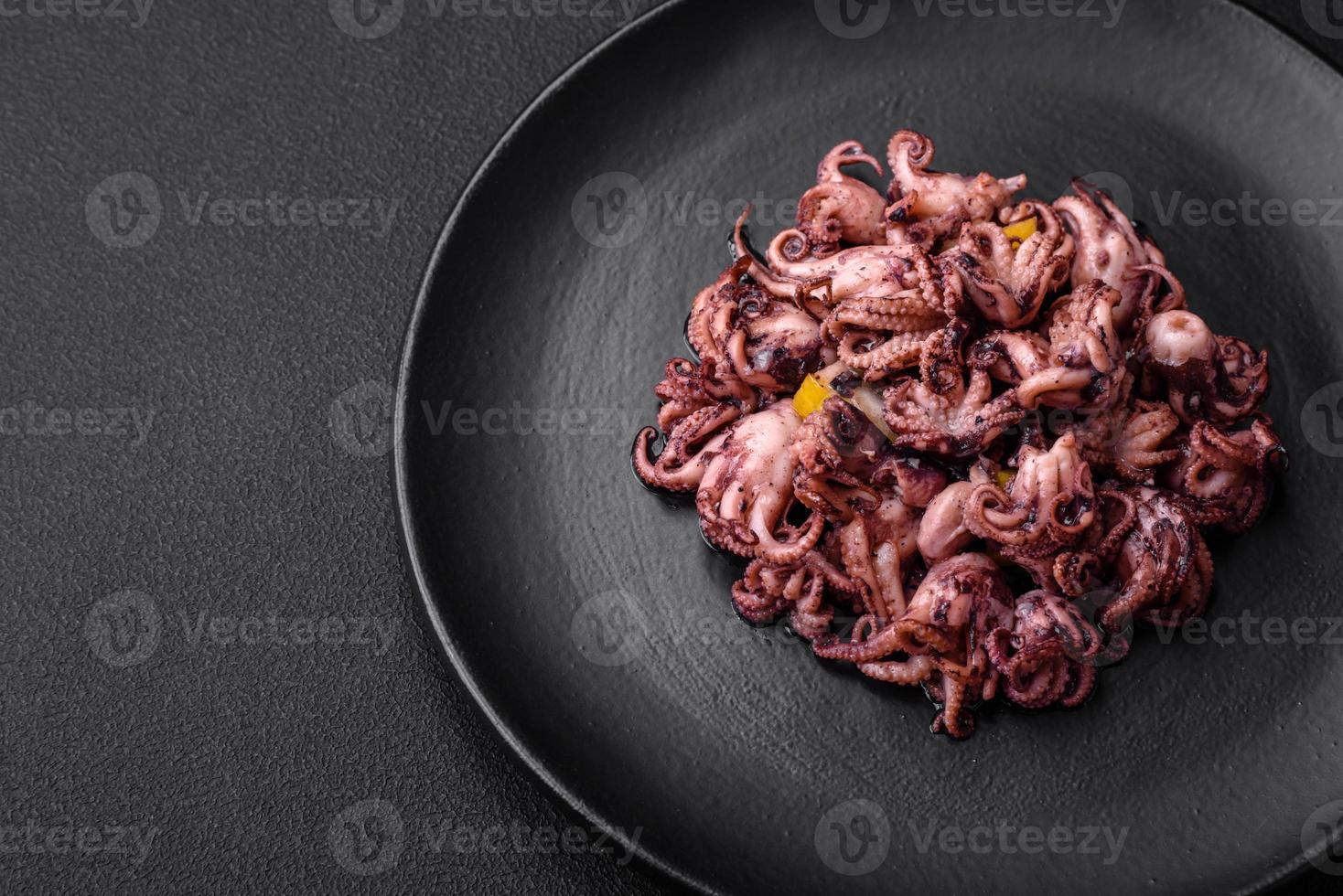 Delicious marinated octopus babies with lemon, salt and spices photo