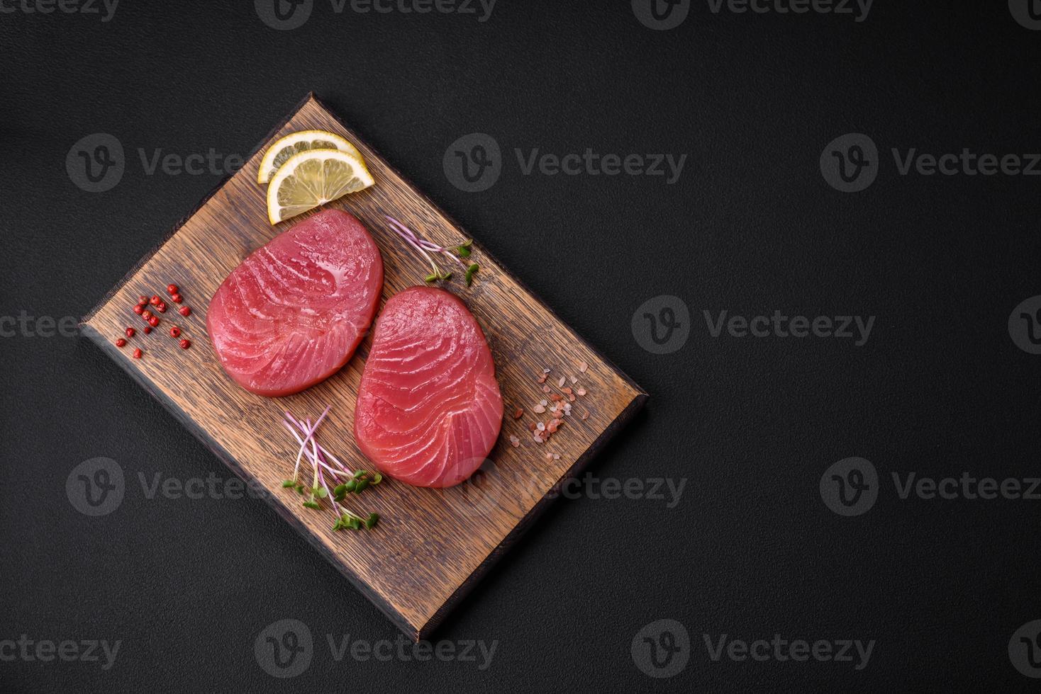 Two fresh slices of raw tuna fillet with spices and herbs photo