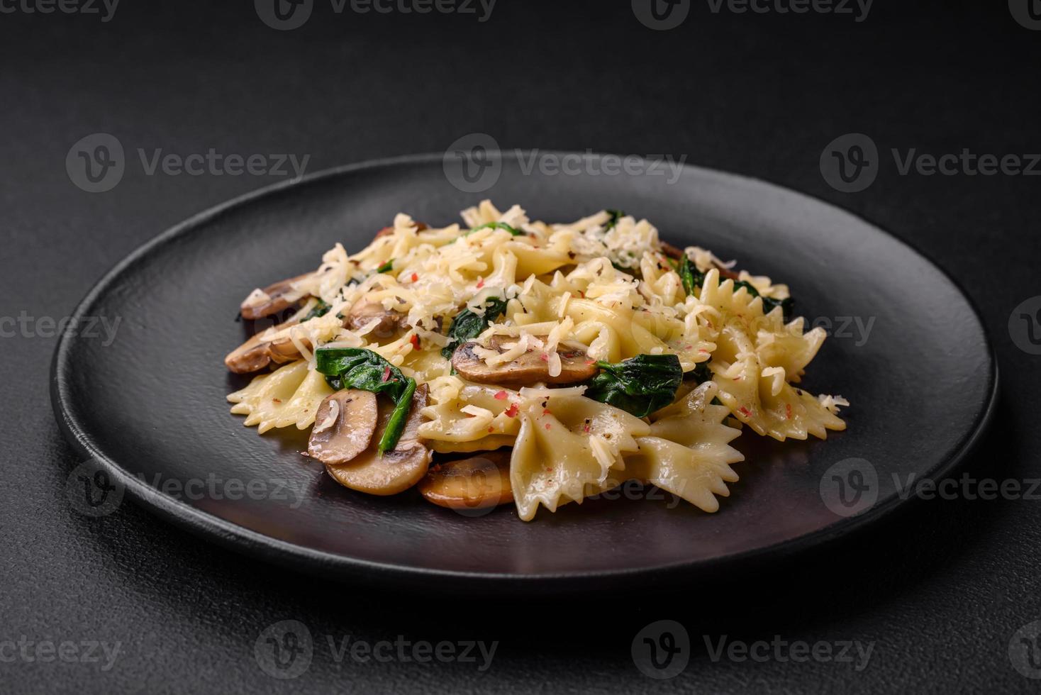 Delicious farfalle pasta with mushrooms, cheese and spinach with spices photo