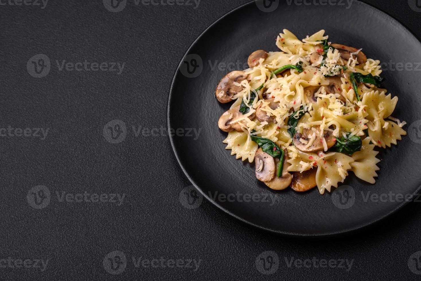 Delicious farfalle pasta with mushrooms, cheese and spinach with spices